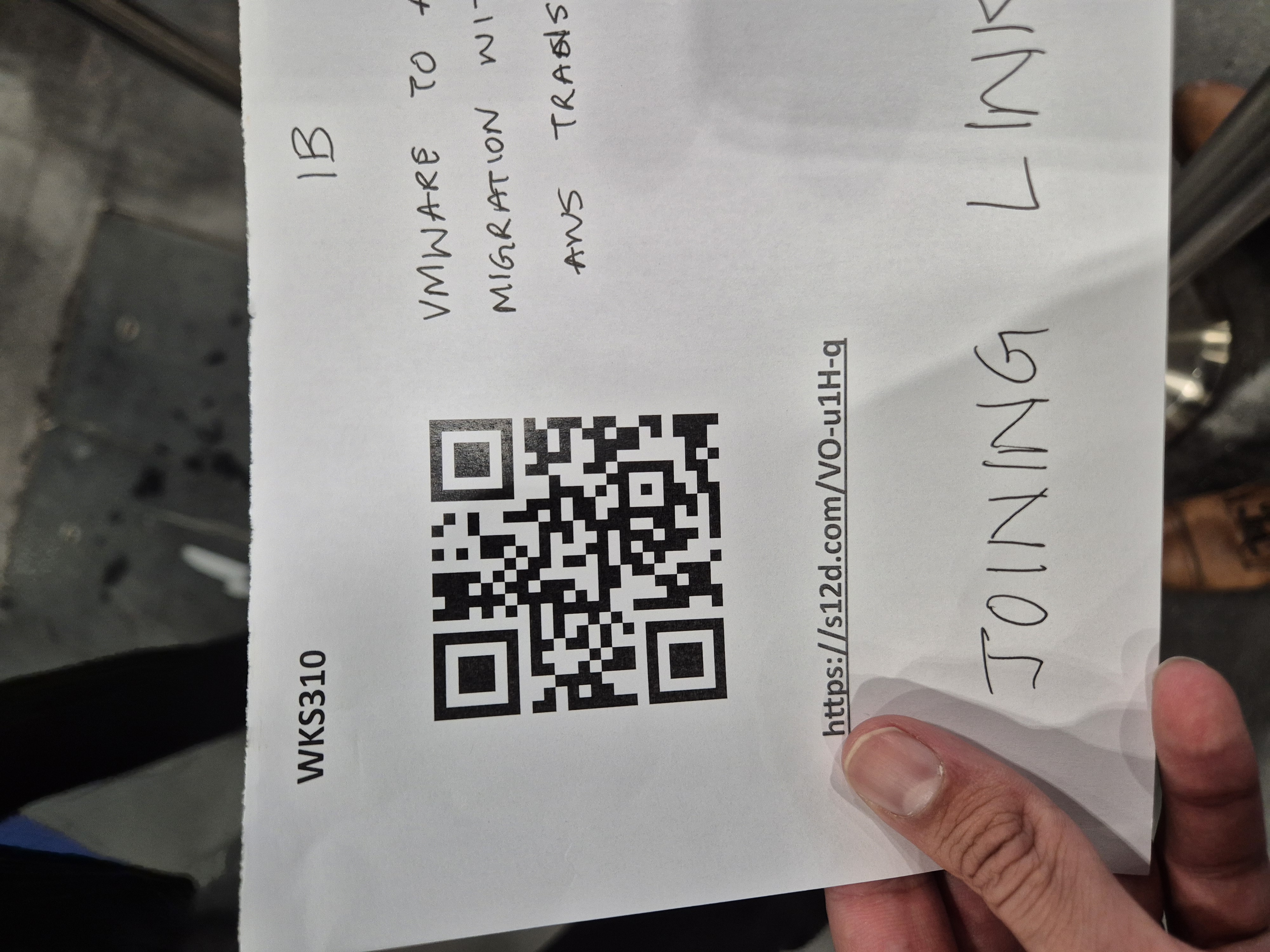 Workshop slip with QR code and handwritten note for the VMware migration with AWS Transform session