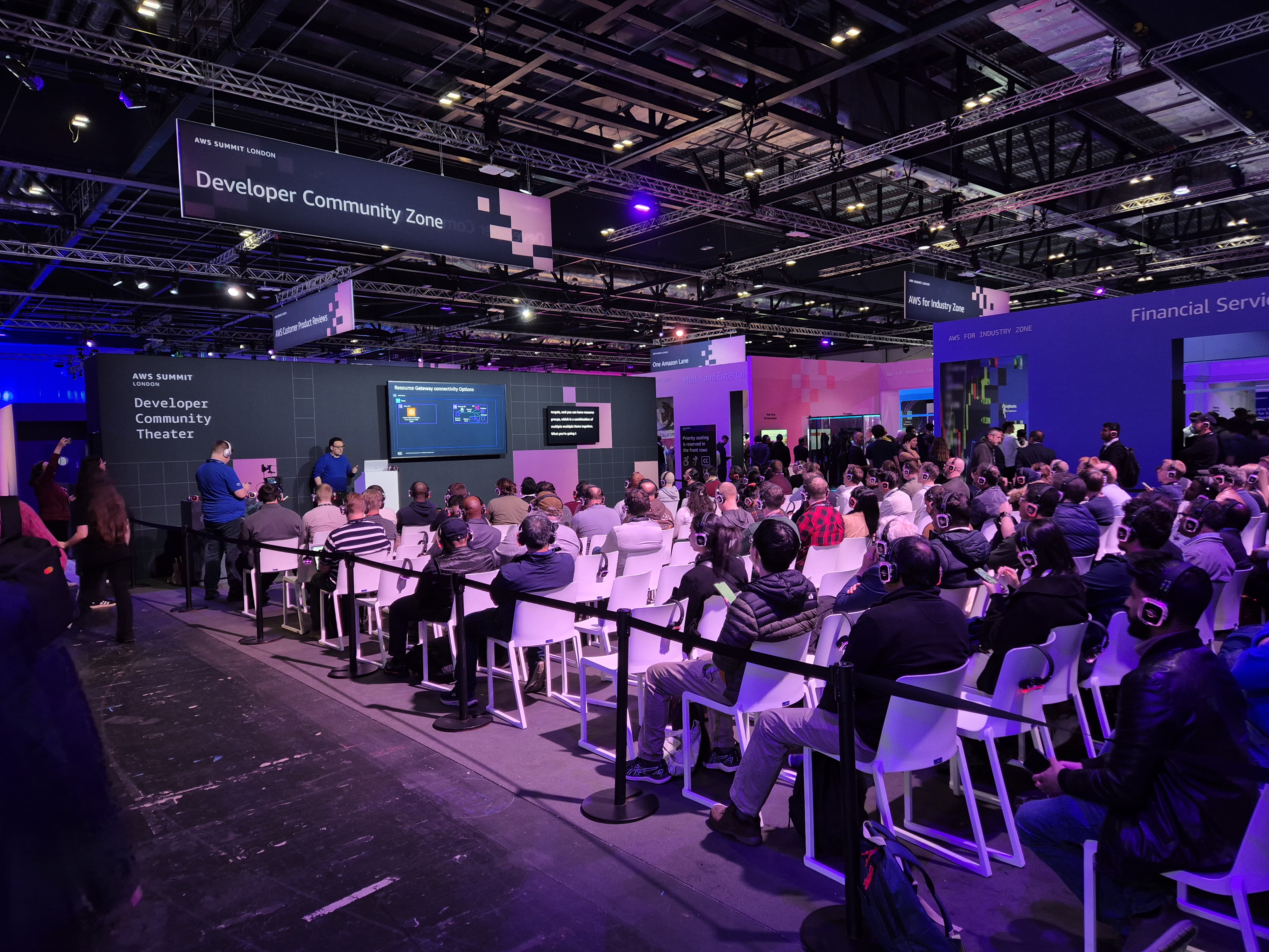 Crowded AWS Summit London 2026 Developer Community Zone session showing the scale of the floor and the audience around the theater space