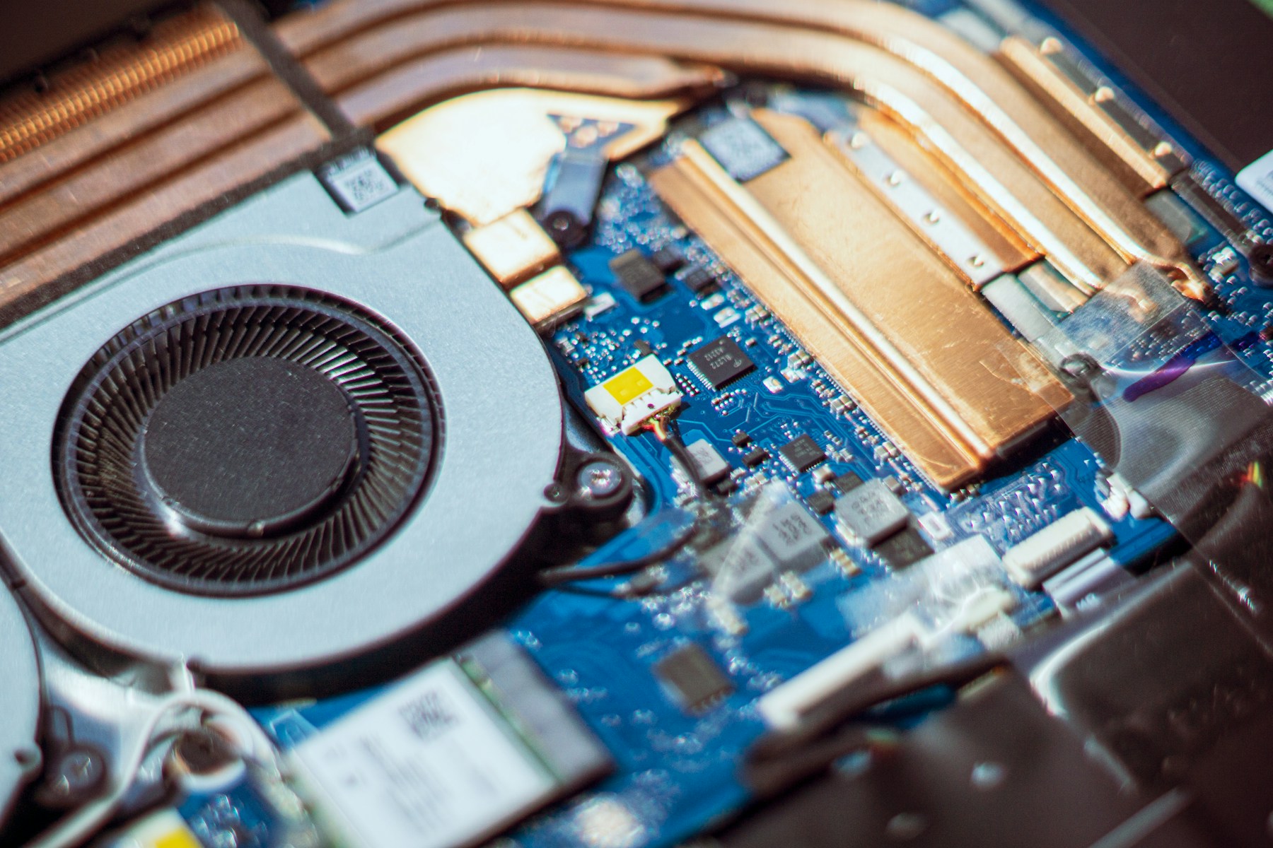 The internal cooling system of a laptop with two fans and heat pipes visible