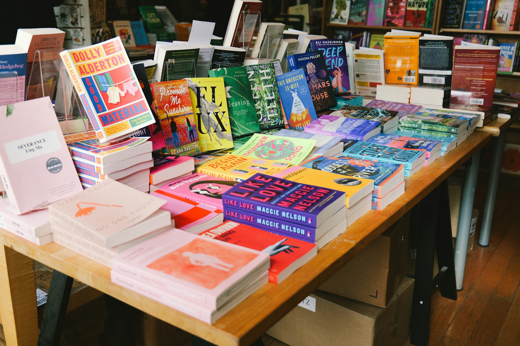 Colourful books arranged across a display table inside a bookshop