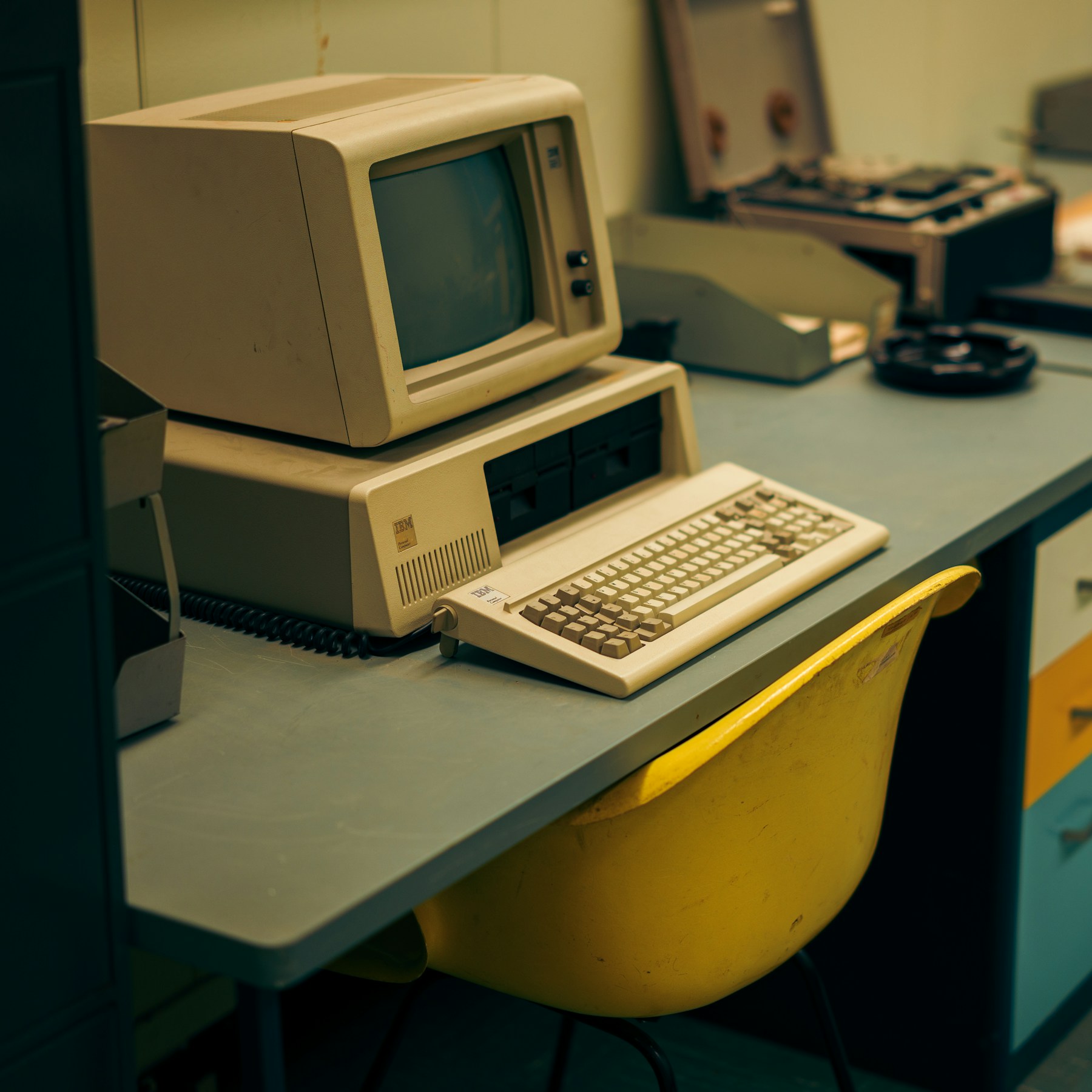 An early IBM personal computer with a CRT monitor, keyboard and floppy drives